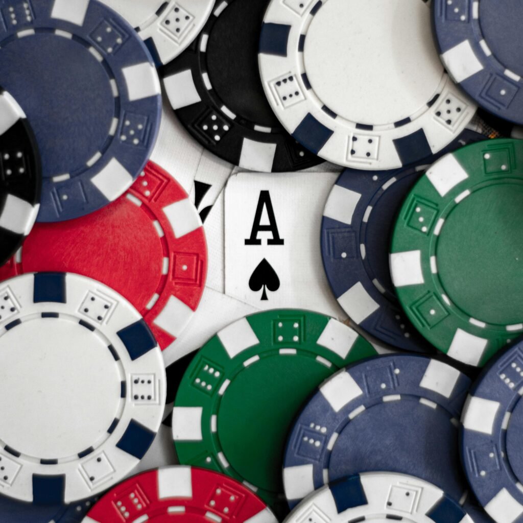 Close-up of poker chips with an ace of spades card, perfect for casino themes.